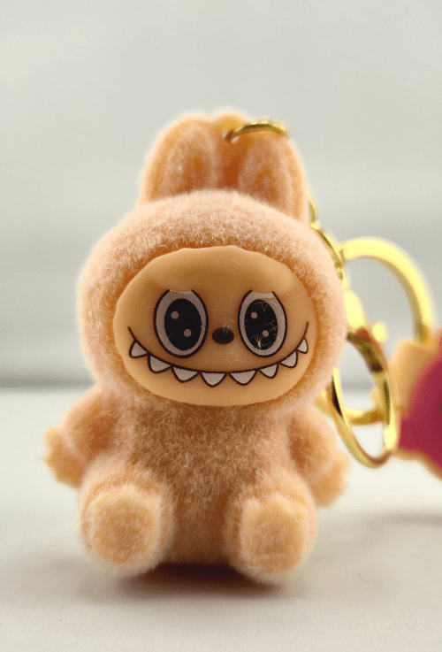 Monster sleutelhanger licht roze zittend